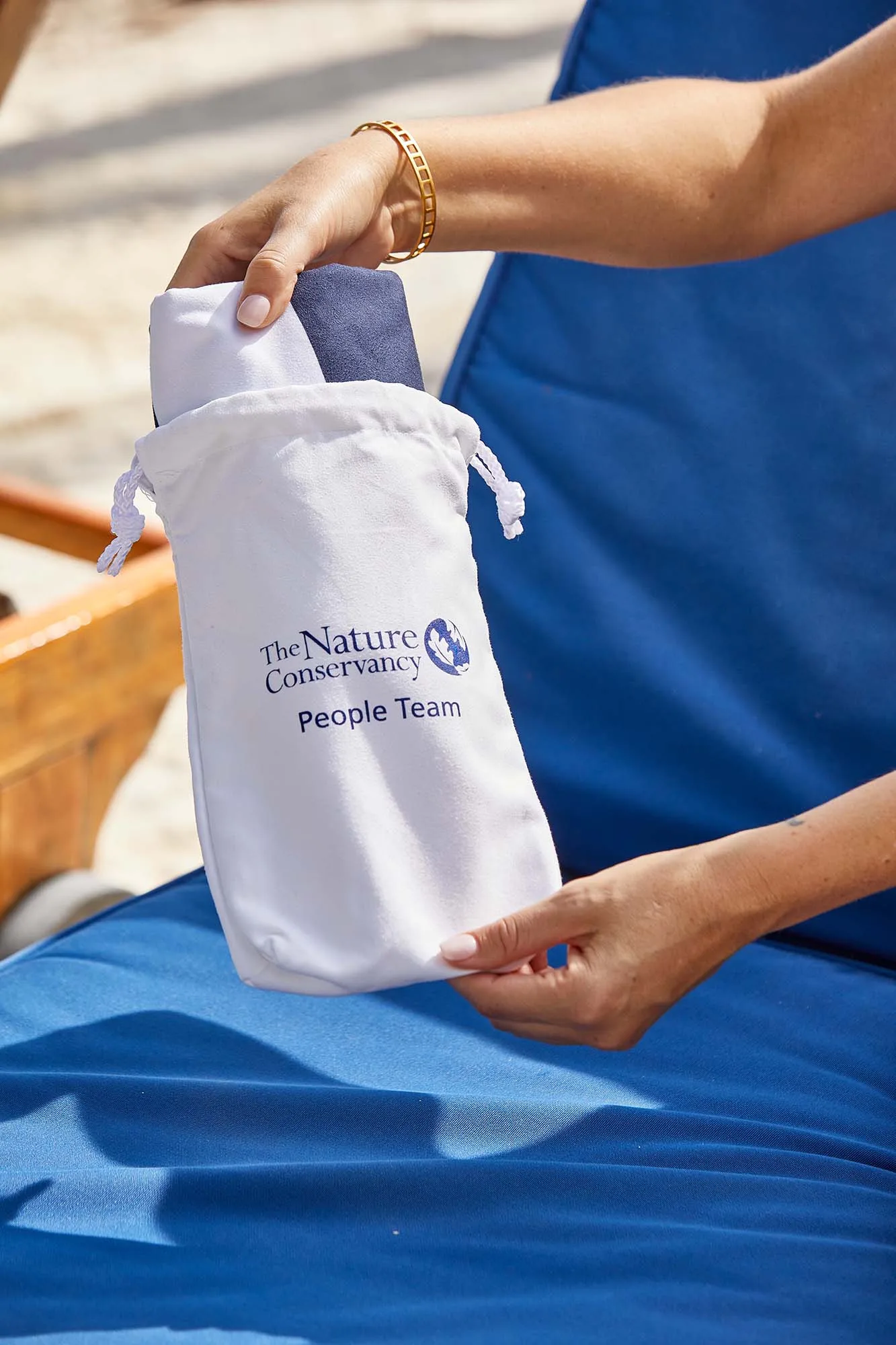 Beach towel ships inside printed drawstring bag.